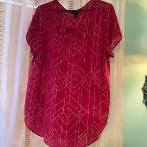 Raspberry blouse with white deco pattern